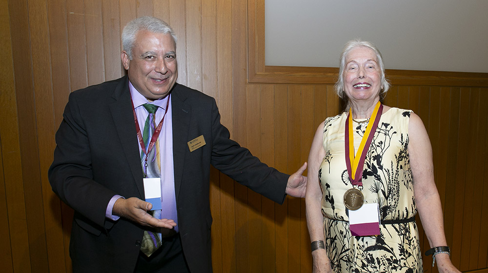 Dean Marzo smiling and standing next to Dr. Eva Bading who is smiling and proudl